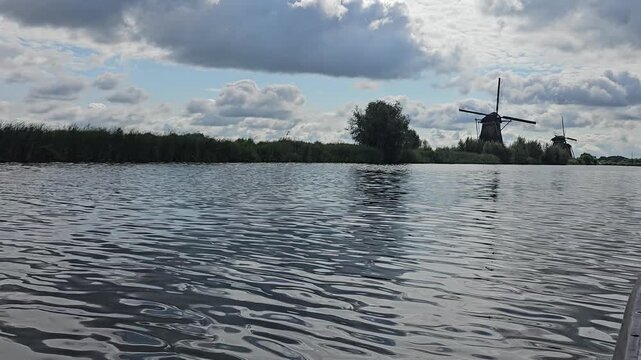 Windmill viewed from the boat throught the canal netherlands