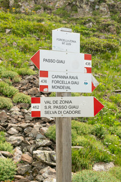Passo Giau, Italy. Alpine hiking trail sign directing walkers toward Mondeval, Forcella Giau and Selva di Cadore