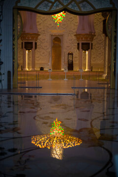 Bright and colourful lamp shining on a reflected marble floor in a religious temple Mosque in Abu Dhabi