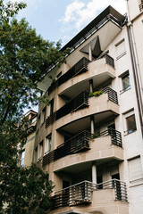 A modern residential building with stacked balconies stands in Belgrade Serbia. The facade suits real estate housing architecture rental and investment themes. © Ekaterina