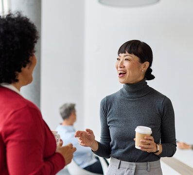 Portrait of two young business woman having a meeting or presentation and seminar standing in the office. Portrait of a young business woman talking