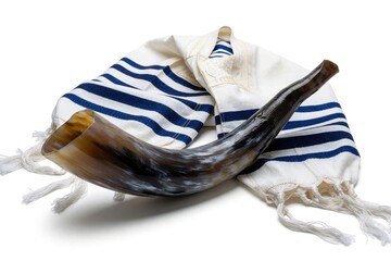 Obraz premium Jewish shofar horn rests on white tallit prayer shawl. Traditional ritual objects for Rosh Hashanah, Yom Kippur holidays. Religious items isolated on white background for Jewish New Year celebration.