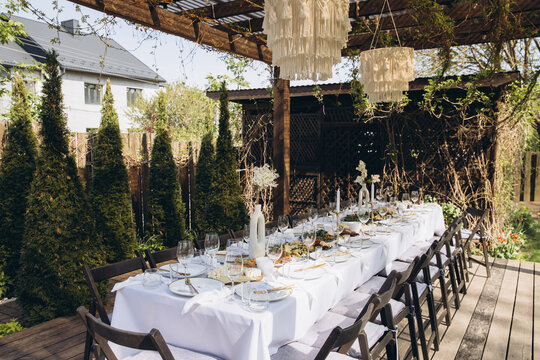 Outdoor dining table set for a summer backyard party or elegant garden wedding celebration
