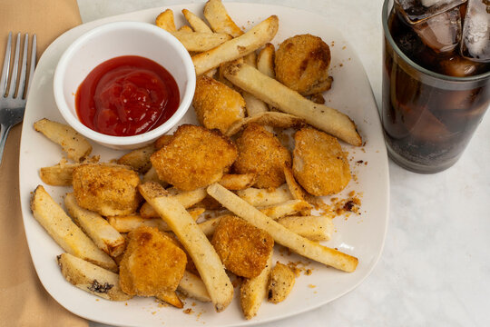 cod bites  along with  french fries  and soda
