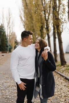 Couple walking along a tree-lined path