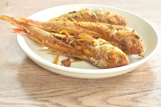 deep fried whisker sheatfish or bleeker sheatfish with turmeric sauce on plate