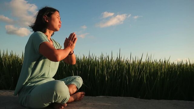 Young woman practicing yoga and meditation in a peaceful outdoor setting at sunset. outdoor wellness activity