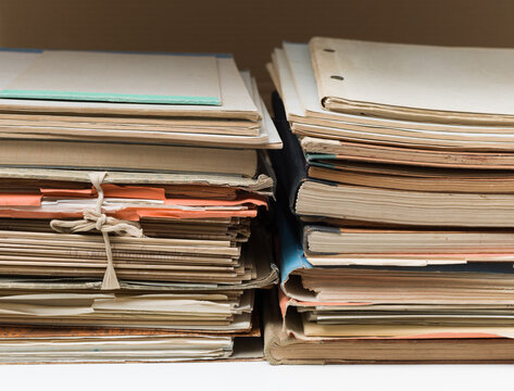 Stacked vintage file folders with documents