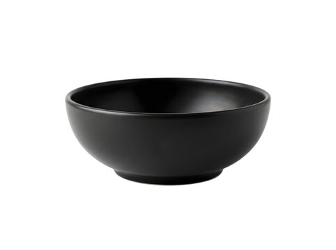 A single empty black ceramic bowl for serving food on a kitchen table isolated on transparent background