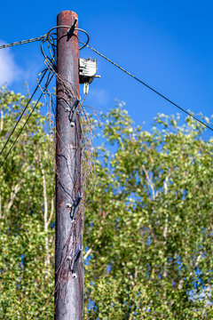 Pole Mounted Telecommunications Distribution Box and Network Cables on a Wooden Utility Pole