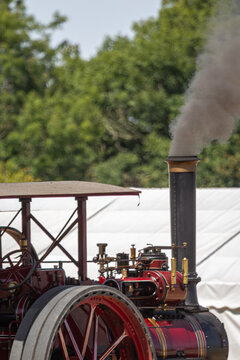 Vintage Steam Traction Engine With Smoke Rising From Chimney at a Traditional Outdoor Country Show