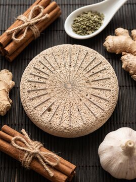 Acupuncture practice pad with herbal supplements and aromatic spices