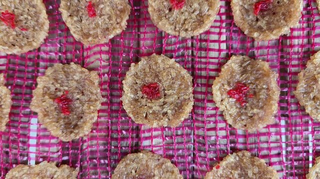 Top View Traditional Sweet Coconut Cookies Dry on Pink Mesh Tray