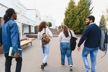 Fototapeta premium Diverse students walking on university campus, friendship developing