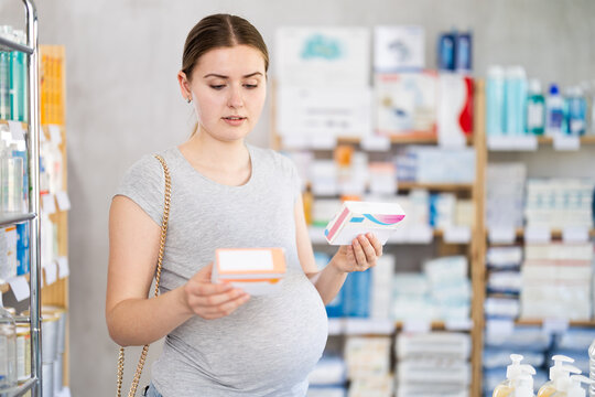 Pregnant woman buyer select buys vitamins medicine