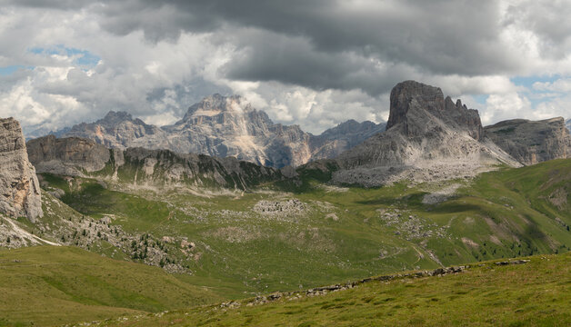San Vito di Cadore, Italy. Mondeval mountain landscape in the Dolomites with alpine meadows, dramatic rock formations and storm clouds