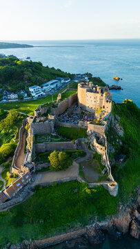 Gorey Castle (Mont Orgueil Castle) on the coast of Jersey, Channel Islands &mdash; aerial drone view of the historic medieval fortress overlooking the English Channel, Gorey Harbour and green coastal land