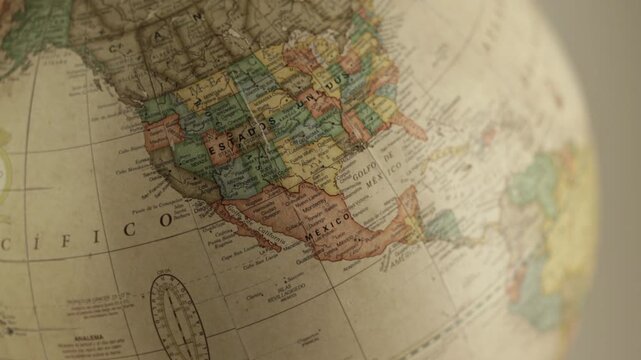 The globe displays details such as national borders&mdash;including the United States, Mexico, and Canada&mdash;as well as the Pacific and Atlantic Oceans, all rendered in warm, aesthetic cream tones.