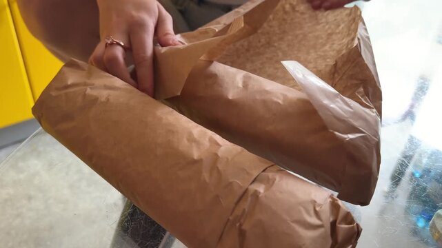 Complete shawarma preparation shows seasoned meat roasting on a vertical rotisserie, flatbread filled and wrapped, then unwrapped and bitten to reveal the juicy filling inside. Close up.