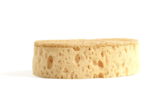 There is one dishwashing sponge lying on a white background.