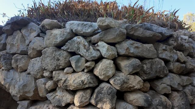 Ancient dry stone cabin surrounded by Mediterranean vegetation