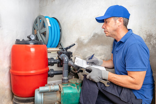 Technician inspecting pool filtration system