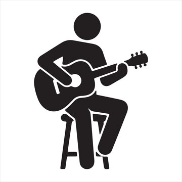 a men setting on the chair and playing gitter