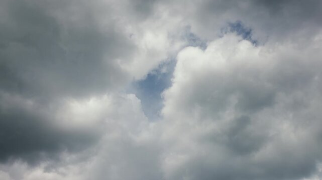 Clouds moving across a blue sky in a time-lapse, showing changing weather patterns, atmospheric movement, sunlight and natural sky conditions for weather and environmental content.