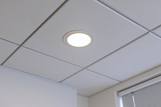 The recessed ceiling light fixture in a clean modern office space