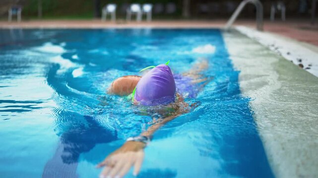 Female athlete training in swimming pool, demonstrating discipline, determination and consistent practice while pursuing peak physical performance and sporting excellence.