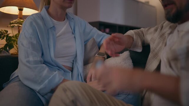 Couple arguing while man shows something on his smartphone to upset woman, representing relationship conflict, jealousy, digital communication, mistrust and emotional tension.
