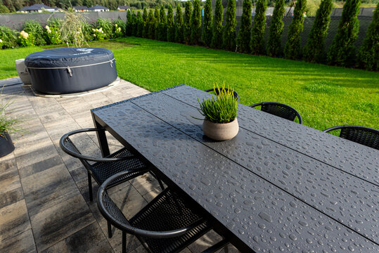 Outdoor dining table with water drops and hot tub