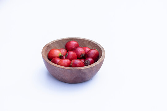 Liberica coffee (Coffea Liberica) on a white background, raw coffee. Large red Liberica coffee.