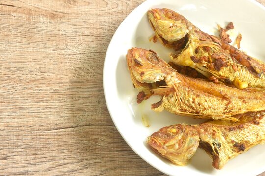 deep fried whisker sheatfish or bleeker sheatfish with turmeric sauce on plate