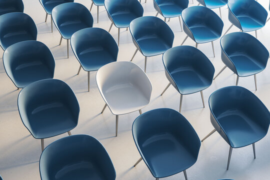 Modern blue and white seats arranged in an empty contemporary auditorium interior for education, business, and graduation events. 3D Rendering