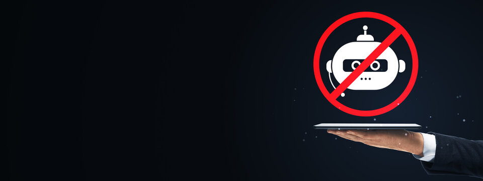 Stop AI chatbot concept with prohibited robot symbol above tablet, business hand presenting technology warning on dark background with copy space.