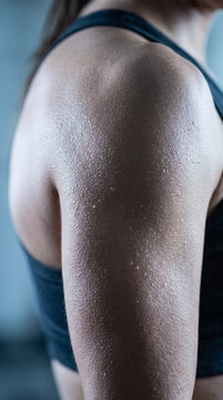 Close Up of Sweaty Shoulder and Arm of Fit Woman During Intense Gym Fitness Workout