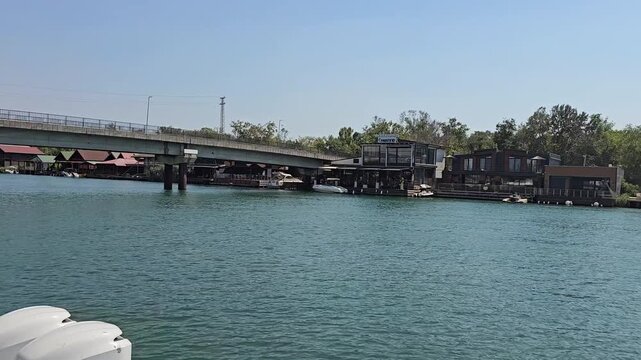 bridge over buna river in ulcinj montenegro with houses and boats video