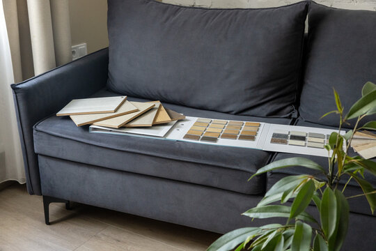 Flooring and furniture material samples on sofa for home interior design