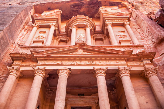 Looking up at the front facade of Al-Khazneh, the Treasury of the Pharaoh, in Petra, Jordan. This rose city was the capital for the Nabateans, and this tomb dates back around 2000 years.