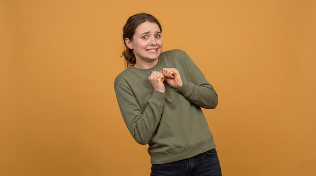 Embarrassed young woman cringing with sticky fingers.