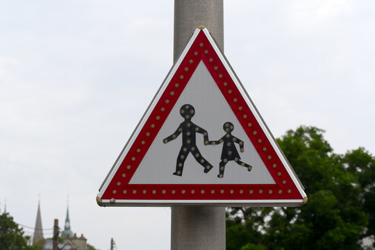 Close-up of traffic sign beware of school children crossing at French city of Bayeux on a summer day. Photo taken July 14th, 2026, Bayeux, Normandie, France.