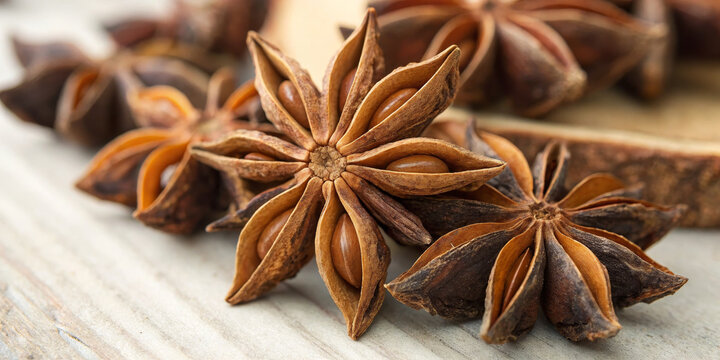 Star anise spice dried aromatic brown close up seed pod culinary ingredient natural rustic flavor herb seasoning food macro healthy organic botanical Asian fragrant cluster wooden background
