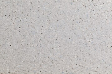 Fototapeta premium The Concrete Surface Closeup of Weathered, Rough, Speckled Neutral Texture Details