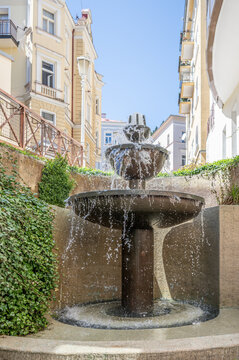 Stone Fountain between Historic Buildings in Marianske Lazne