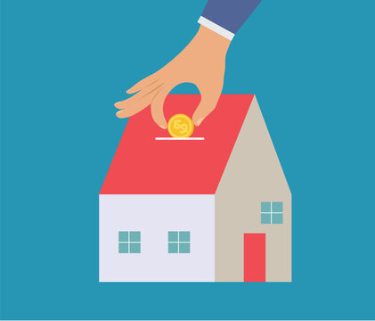 Human hand puts a coin into small house. Investing money in real estate property. Loan, rent and mortgage