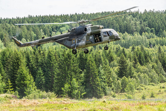 Military Helicopter Flying Low over a Forest