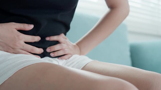 stomach ache. Asian women have abdominal pain, indigestion, gastritis, menstrual cramps, flatulence, diarrhea, distention, colon cancer, belly inflammation problem, suffer food poisoning, abdomen