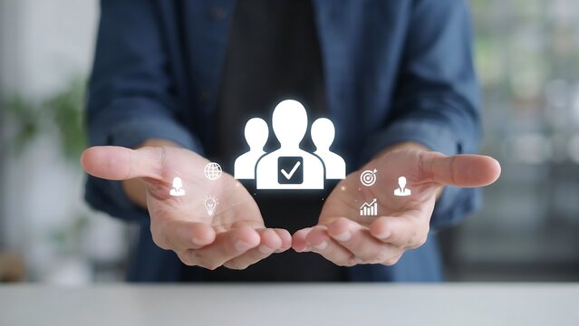 Businessman holding digital human resources icon for talent management and recruitment.