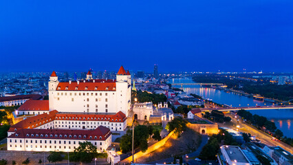 Bratislava skyline at night with the castle and danube river view. Bratislava at night with the castle illuminated beside the Danube River. © Vadim